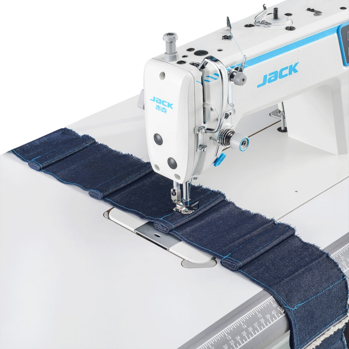 JACK A2C-C High-Speed Single Needle sewing machine stitching blue denim fabric on a white background