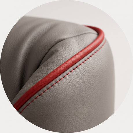 Red piping seam on a grey leather upholstered cushion